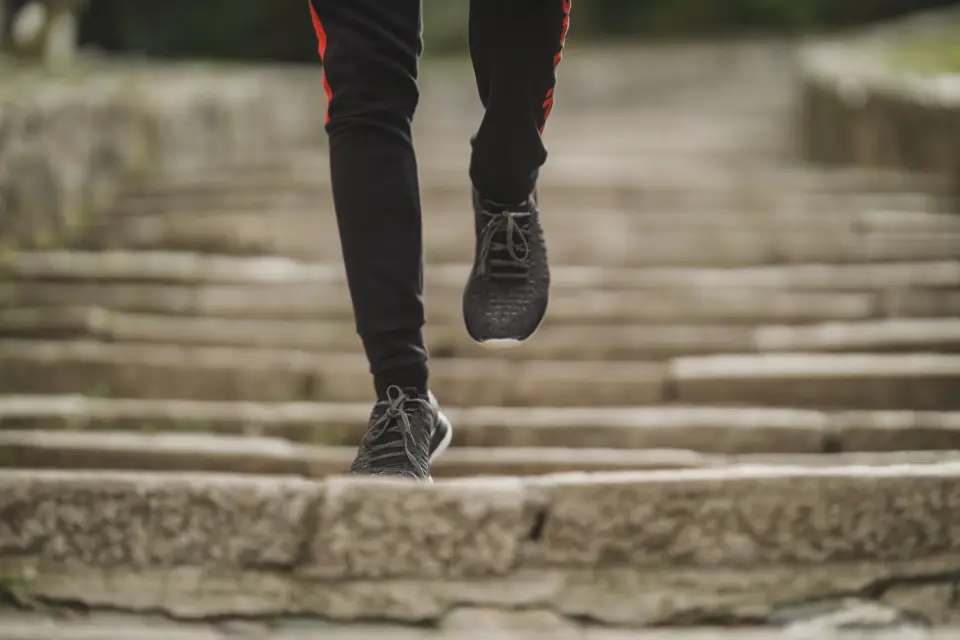 Runner climbing a flight of stone steps
