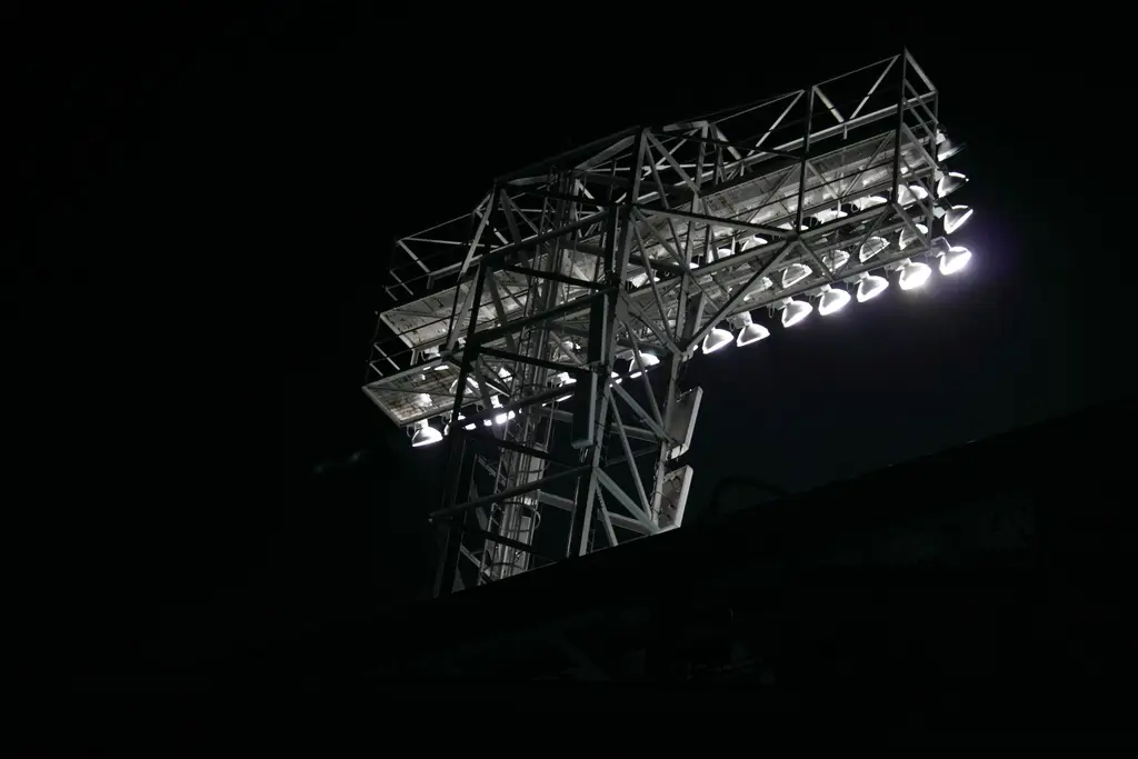 Stadium floodlights against the night sky