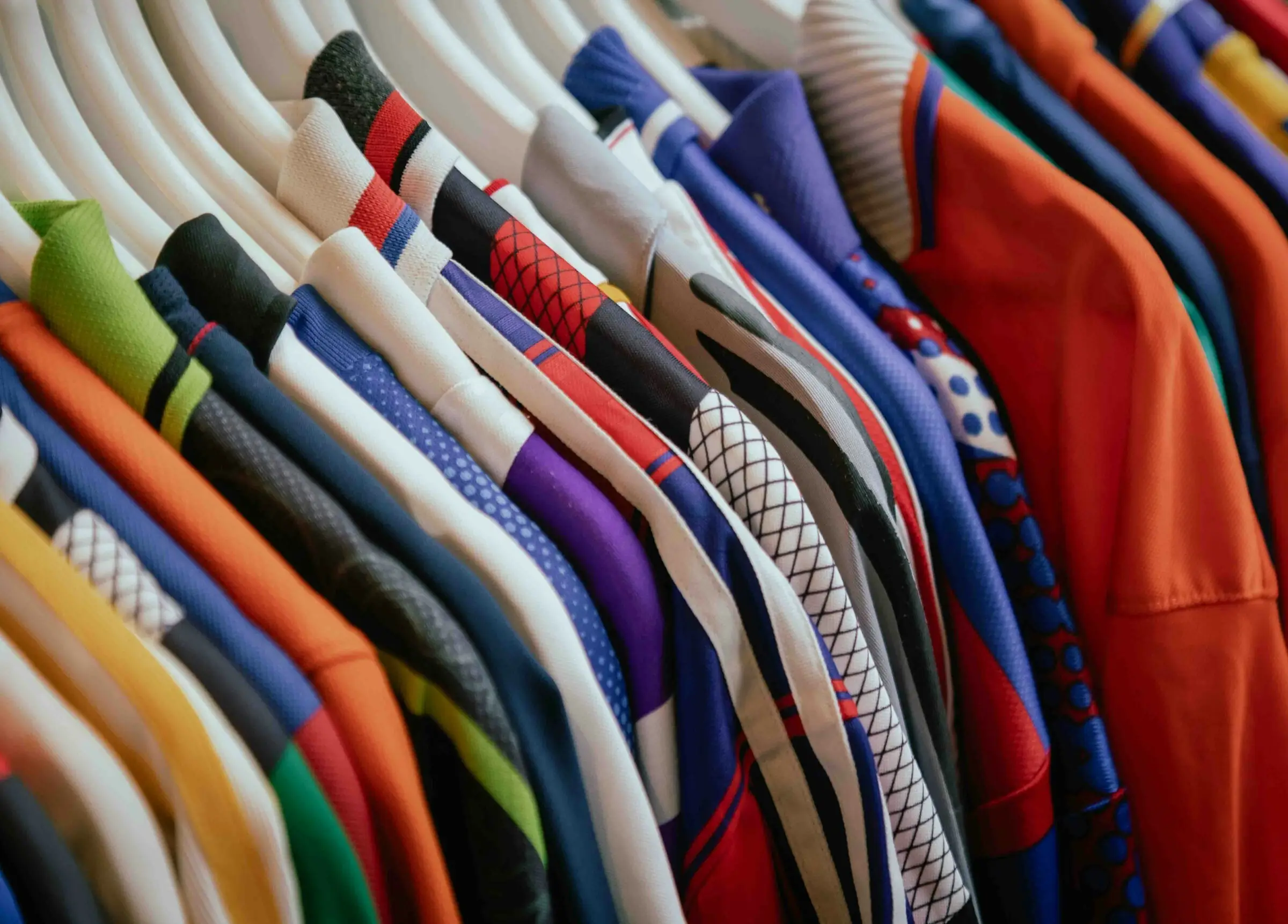 A rack of colourful sports jerseys and shirts