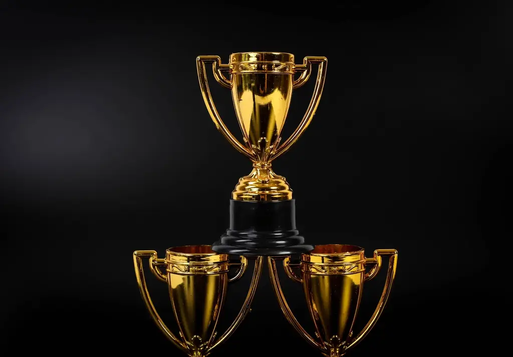 A trophy lit by a spotlight against a black background