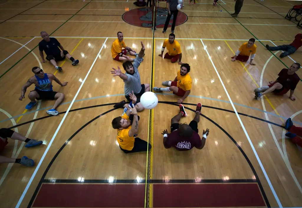 Athletes leaping to spike a volleyball at the net